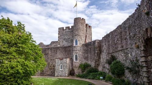 an old castle with a flag on top of it at The Berwick Inn in Polegate