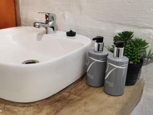 a white sink with two bottles next to it at Kingfisher Bush Lodge in Enkovukeni