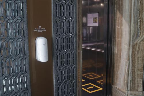 a door with a white object on it next to a glass door at Crowne Plaza Bandung by IHG in Bandung
