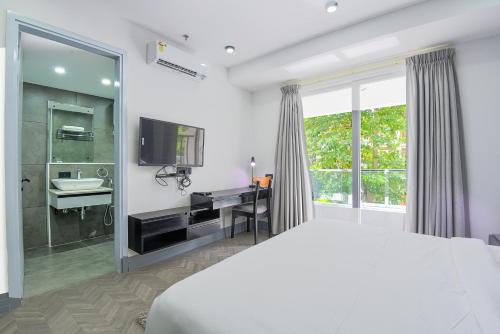 a bedroom with a bed and a sink and a shower at BedChambers Serviced Apartments, MG ROAD in Gurgaon