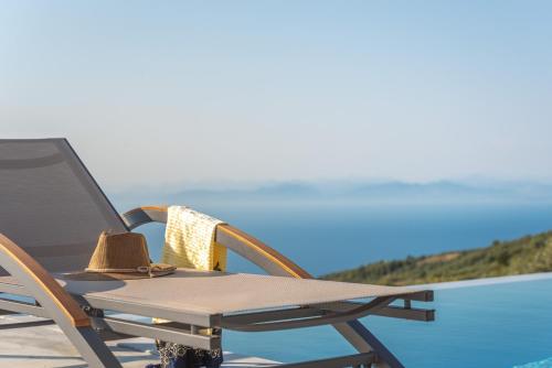 a deck chair with a hat and a hat on it at Owl Villas in Drymon