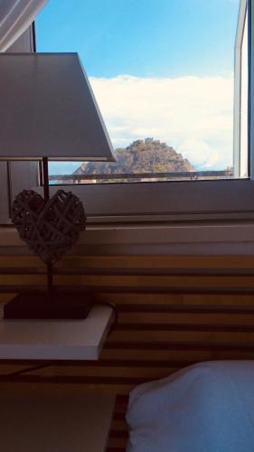 a bedroom with a window with a bed and a lamp at Blue Sky Apartments in Capo dʼOrlando