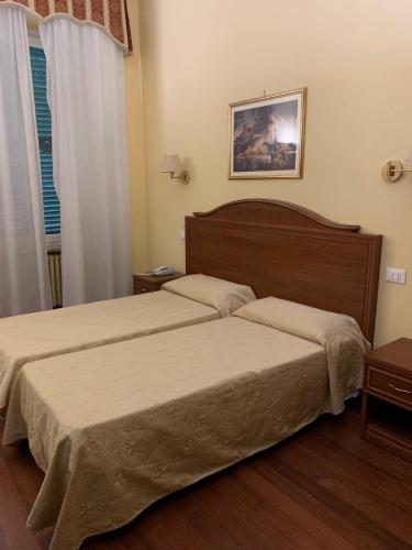Postel nebo postele na pokoji v ubytování Hotel Villa Aricia