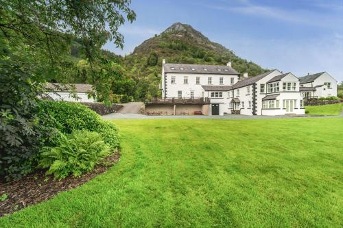 an exterior view of a house with a green lawn at Lords Seat in Keswick