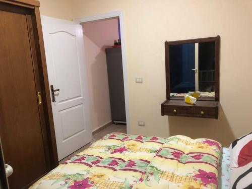 a bedroom with a bed and a dresser and a mirror at Tahiti North cost تاهيتي الساحل الشمالي in Al Ḩammām