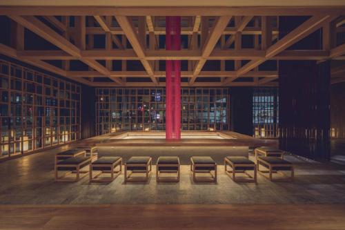 a room with a row of chairs and a red pole at Tokyu Stay Hida Takayama Musubinoyu in Takayama