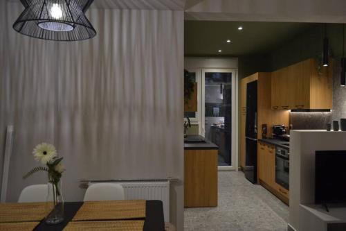 a kitchen and dining room with a dining table and a dining room at GREEN HOUSE in Kardítsa