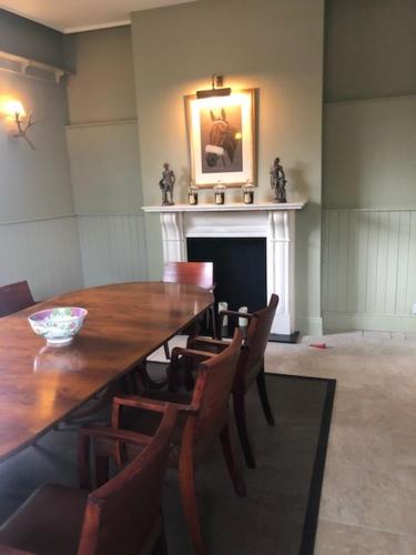a dining room with a table and chairs and a fireplace at Flynns of Termonfeckin Boutique Hotel in Termonfeckin