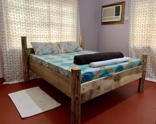 a bed in a room with a pillow on it at Pazuri Hostel in Moshi