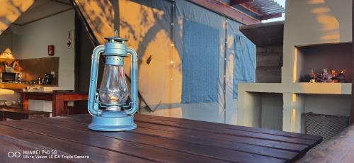 a lantern sitting on top of a wooden table at Kingfisher Bush Lodge in Enkovukeni