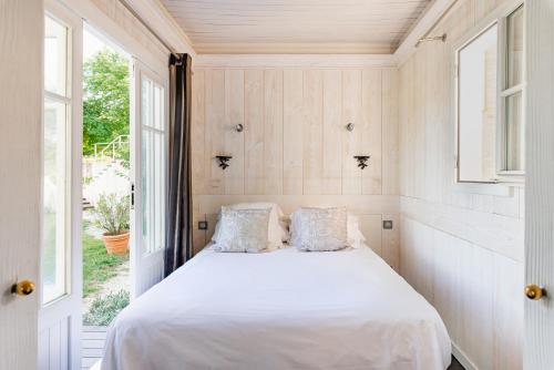 a bedroom with a bed and a window at La Petite Aiguebonne in Allex