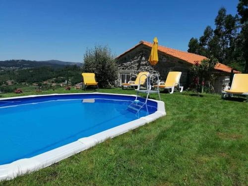 a pool in the backyard of a house at Casa Pedra & Cal in Paredes de Coura
