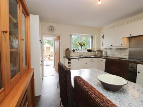 a kitchen with a table with a bowl on it at 3 Springfort Cottages in Penrith