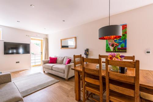 a living room with a table and a couch at Brecks Farm - The Mill in York