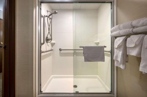 a shower with a glass door in a bathroom at Comfort Inn in Millersburg
