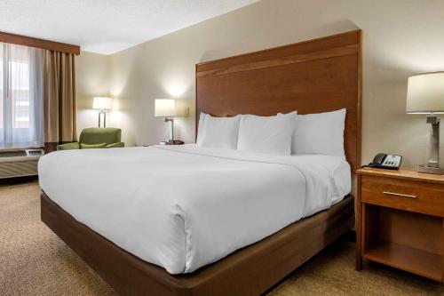 a hotel room with a large bed and a telephone at Comfort Inn in Millersburg