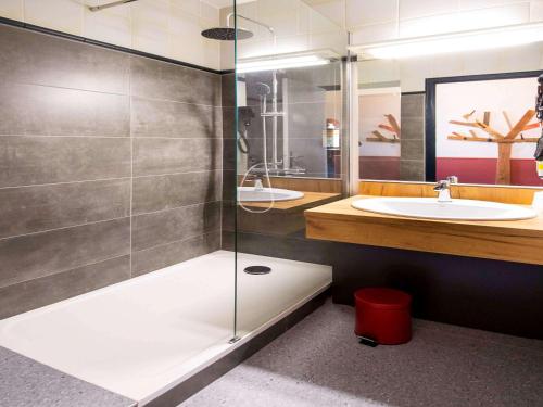 a bathroom with a shower and a sink at Greet Hôtel Castres Saix in Saix