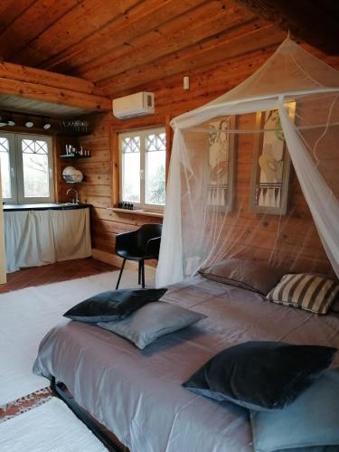 a bedroom with a bed in a wooden cabin at Brīvdienu māja Mākoņi in Ratnieki