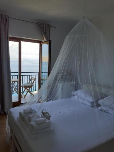 a bedroom with a bed with a mosquito net at Room Domo in Senj