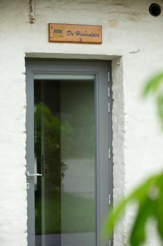 a door to a building with a sign above it at De Grote Linde in Oostkamp