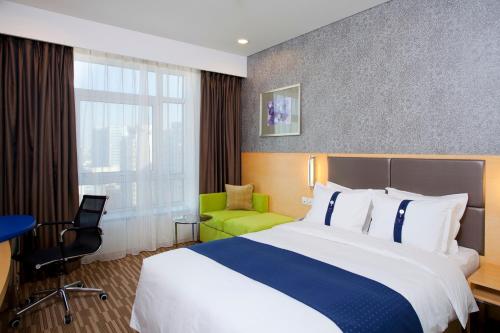 a hotel room with two beds and a desk at Holiday Inn Express Beijing Dongzhimen, an IHG Hotel in Beijing