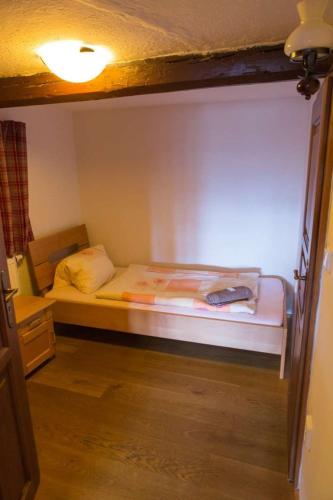 a small bedroom with a bed in a room at Penzion U Zlomené lyže in Železná Ruda