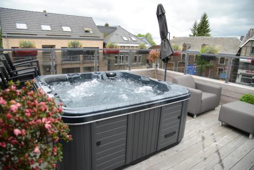 a hot tub on top of a deck at Race & Rooms Appartment in Stavelot