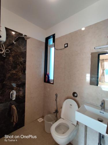 a bathroom with a toilet and a sink at ROYAL MEADOWS IGATPURI 2BHK POOLSIDE VILLA in Igatpuri