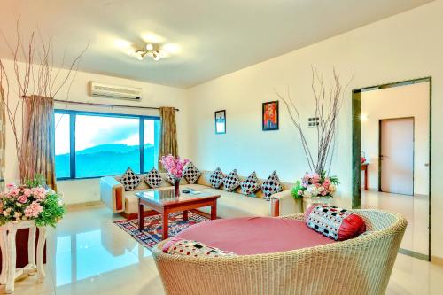 a living room with a couch and a table at Mystic Valley Spa Resort, Igatpuri in Igatpuri