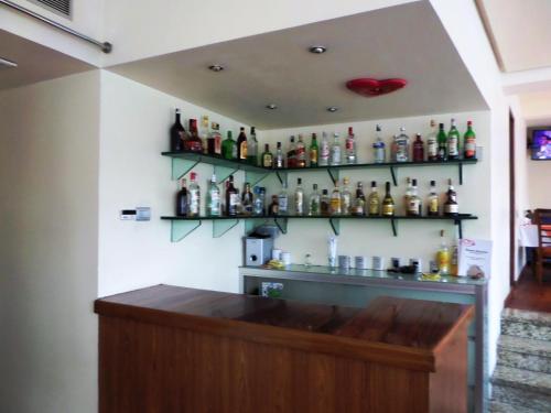 a bar with a bunch of bottles on the wall at Hotel Cuore in Mexico City