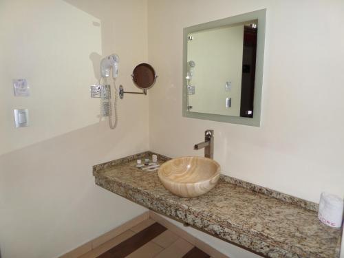 a bathroom with a wooden sink and a mirror at Hotel Cuore in Mexico City
