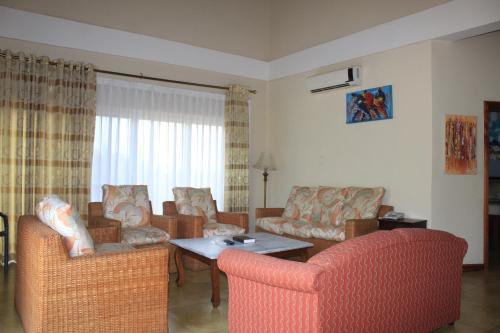 a living room with couches and a table at Bojo Beach Resort in Bortianor