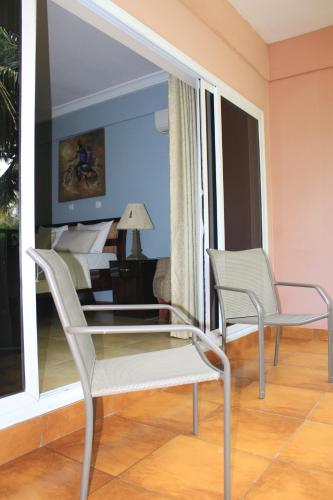a living room with two chairs and a piano at Bojo Beach Resort in Bortianor