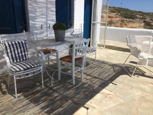 a table and chairs sitting on a patio at Makares in Donoussa