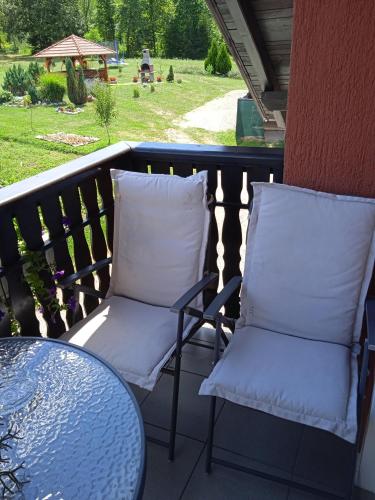 two white pillows sitting on a balcony with a table at Nika in Ogulin