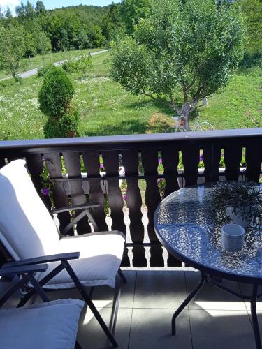 a table and chairs on a balcony with a view at Nika in Ogulin