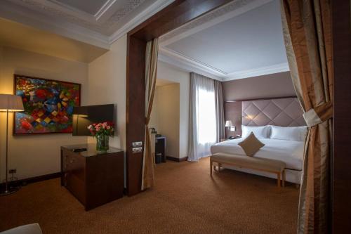 a hotel room with a bed and a window at Hotel Atlantic Agdal in Rabat