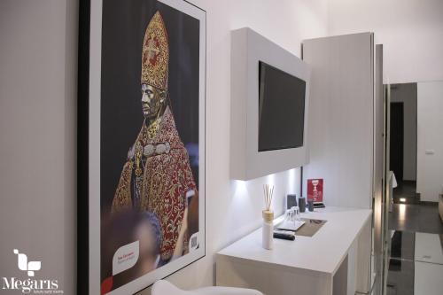 a room with a picture of a woman on the wall at Megaris Luxury Suite Rooms in Naples