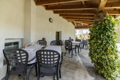 a dining room with tables and chairs and ivy at Hotel Restaurant Sternen in Gelfingen