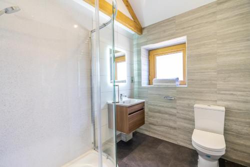 a bathroom with a toilet and a sink at Brecks Farm - The Parlour in York