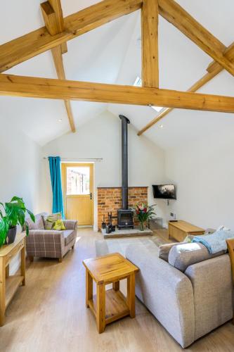 a living room with two couches and a fireplace at Brecks Farm - The Parlour in York