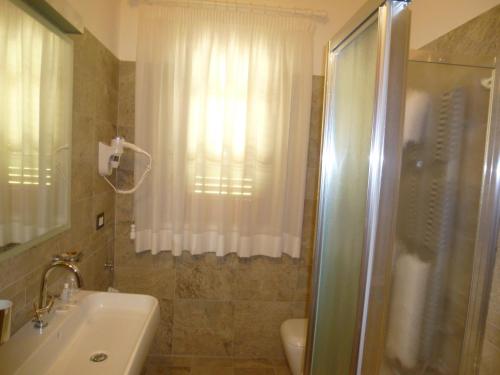a bathroom with a shower and a toilet and a sink at Relais Villa Giulia in Bastia Umbra