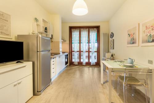 a kitchen with a stainless steel refrigerator and a table at La Terrazza in Brunate