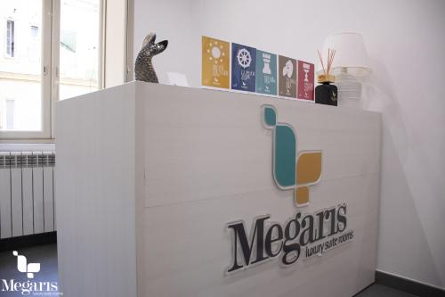 a reception counter with a mexicans logo on it at Megaris Luxury Suite Rooms in Naples