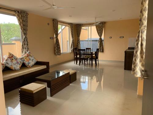 a living room with a couch and a table at ROYAL MEADOWS - IGATPURI Bungalow C in Igatpuri