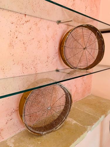 two wicker tennis rackets hanging on a wall at Nonna Veronica in Gemini