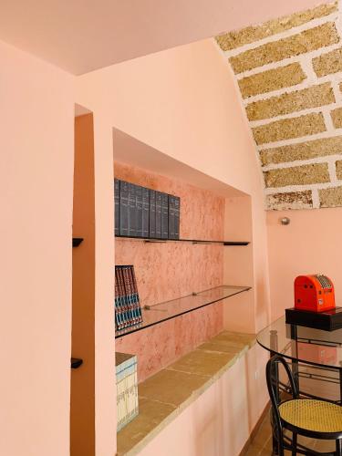 a dining room with a table and a brick wall at Nonna Veronica in Gemini