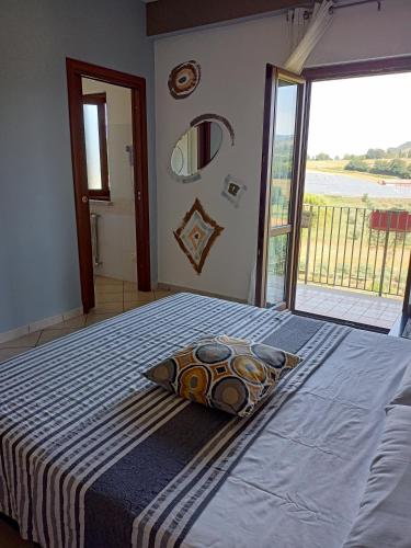 a bedroom with a bed with a pillow and a window at Il Faggio 17 B&B in Artena