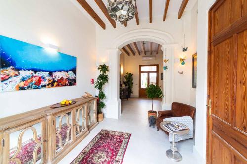 a living room with a large painting on the wall at Flor de Mandarina in Sa Pobla