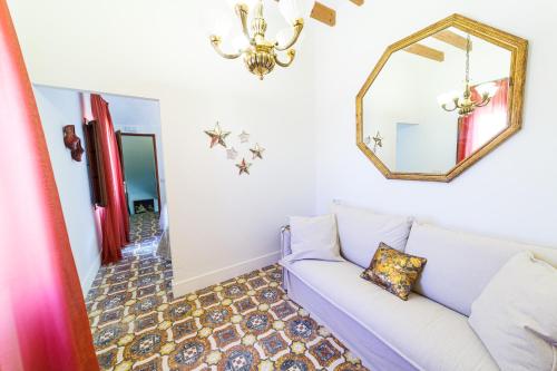 a living room with a couch and a mirror at Flor de Mandarina in Sa Pobla